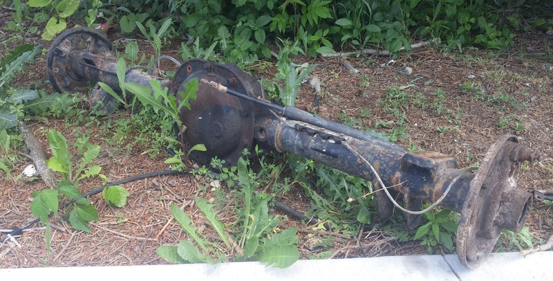 A Chrysler 8.25 axle lurks in the grass.